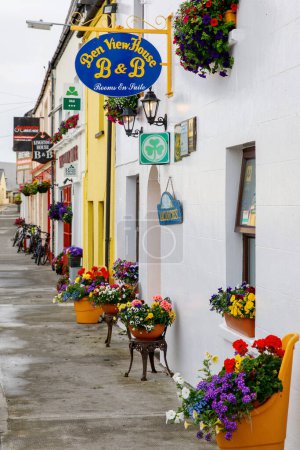 Photo for CLIFDEN, IRELAND - 16 July, 2019: Awesome and colorful streets of Clifden, Connemara, Ireland. Colourful houses, doors, pubs, windows with flowers - Royalty Free Image