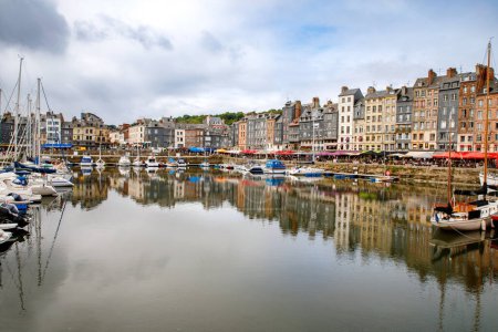 Photo for HONFLEUR, FRANCE - August 23, 2022: View of the picturesque harbour of Honfleur, yachts and old houses reflected in water. - Royalty Free Image