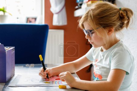 Photo for Cute Little Preschooler Child Drawing at Home. Happy Girl with Colorful Felt Pens. Hobby for Children. Leisure Activity for Small Kids at School - Royalty Free Image