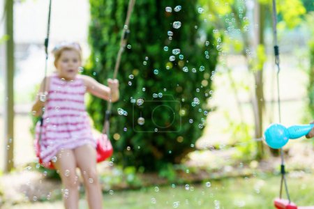 Photo for Happy little preschool girl and school kid boy having fun with blowing soap bubble blower. Children, lovely siblings playing together. Active funny healthy kids. Brother and sister in love - Royalty Free Image