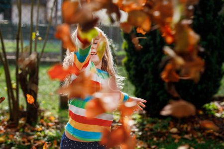 Photo for Fall portrait of little preschool girl in autumn park on warm october day with oak and maple leaf. Child with lot of leaves. Family outdoor fun in fall. Kid smiling. Healthy funny child with glasses. - Royalty Free Image