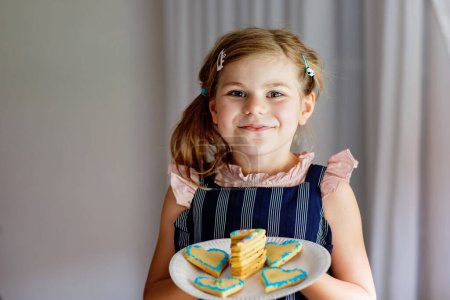 Photo for Happy little preschool girl celebrating birthday. Closeup of child with homemade biscuite cake, indoor. Happy healthy kid indoors. - Royalty Free Image