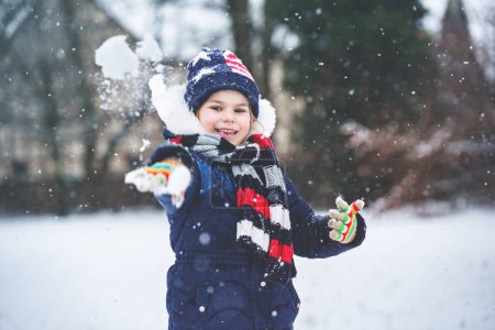 Photo for Cute little preschool girl outdoors in winter park . Adorable healthy happy child playing and having fun with snow, outdoors on cold day. Active leisure with children in winter. - Royalty Free Image