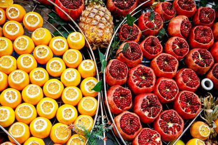 Photo for Fresh pomegranate and oranges at the Grand Bazaar, Istanbul. Flatlay view of orange, pomegranate, lemon, grapefruit filtered image. - Royalty Free Image