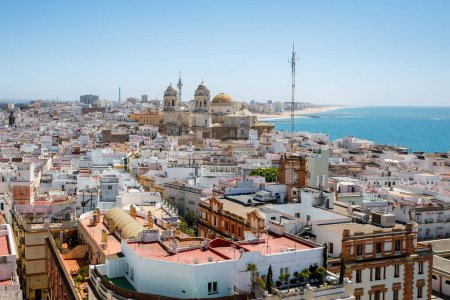 Photo for Aerial panoramic view of the old city rooftops and Cathedral de Santa Cruz in the afternoon from tower Tavira in Cadiz, Andalusia, Spain. - Royalty Free Image