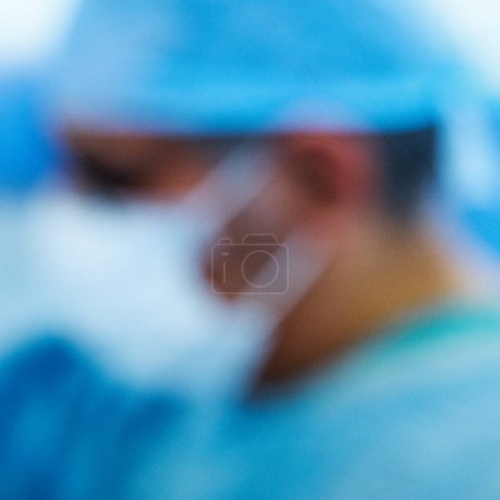 Photo for London UK, November13 2022, Anonymous Blurred Doctors Or Medical Staff Working In A Hospital Wearing Blue Gowns And Protective Face Masks - Royalty Free Image