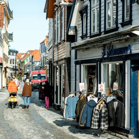 Photo for Stavanger, Norway, March 10 2023, People Walking Around Traditional Historic Old Town Stavanger Shopping Or Sightseeing - Royalty Free Image