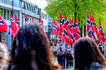 Photo for Sandnes, Norway, May 17 2023, Crowds Watching Norwegian Flag Carrying Parade Main Street Sandnes Norway - Royalty Free Image