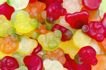 Assorted many colored colorful marmalade gummy candies,Jelly bears.laid out on flat surface.dessert for holiday,sweet gifts for children,texture,background with small candies macro close up.Top view.
