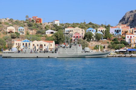 Photo for KASTELLORIZO,GREECE-AUGUST 10:Greek Warship with Unidentified Crew and Colorful Greek Buildings. August 10,2018 in Kastellorizo, Greece - Royalty Free Image