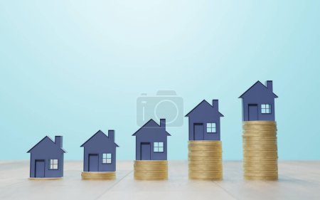 Photo for House symboles sat on stacked coin chart growth - Royalty Free Image