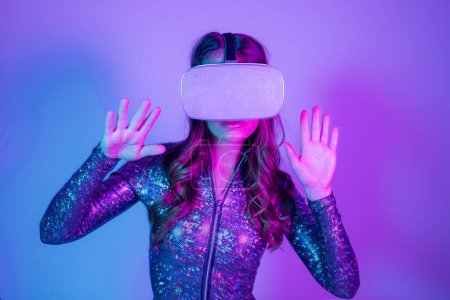Photo for A woman in sparkling costume and VR headset - Royalty Free Image