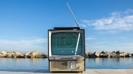 Photo for Retro television with glitch next to the sea - Royalty Free Image