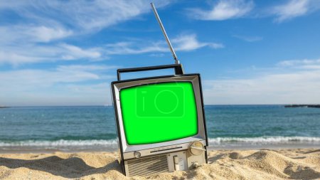 Photo for Retro televisions with green screen next to the sea, to add your own content onto the tvs - Royalty Free Image