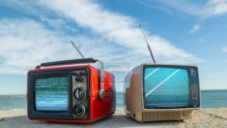 Photo for Retro televisions with glitch next to the sea - Royalty Free Image