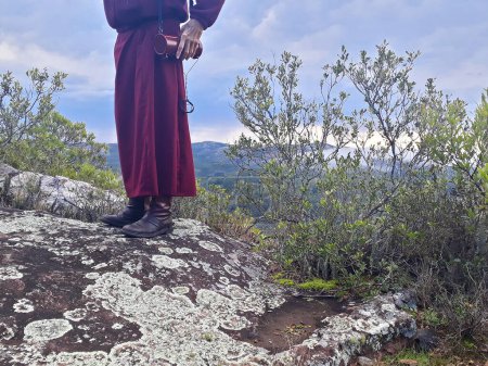 Photo for Buddhist monk guide talking at mountain range landscape - Royalty Free Image