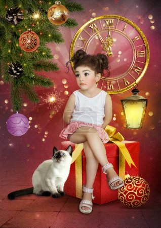 Téléchargez les photos : Une petite fille assise sur une grande boîte avec des cadeaux et un chaton siamois sur le fond de l'horloge du Nouvel An regarde avec admiration le sapin de Noël avec des jouets - en image libre de droit