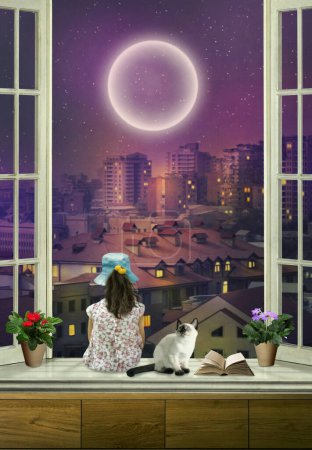 Téléchargez les photos : Une petite fille assise sur le rebord de la fenêtre regarde la ville la nuit, un chaton siamois à côté d'elle - en image libre de droit