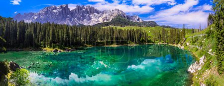 Photo for Idyllic nature scenery- turquoise mountain lake Carezza surrounded by Dolomites rocks- one of the most beautiful lakes of Alps. South Tyrol region. Italy - Royalty Free Image