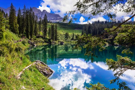 Idyllic nature scenery- turquoise mountain lake Carezza surrounded by Dolomites rocks- one of the most beautiful lakes of european Alps. South Tyrol region. Italy