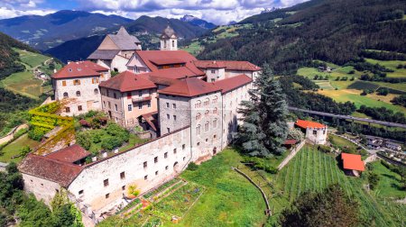 Photo for Italy travel and landmarks .Scenic village Chiusa and it's famous benedictine monastery Sabiona in South Tyrol region , Bolzano province. Aerial drone view - Royalty Free Image
