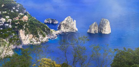 Photo for Most scenic island of Italy and popular resort - beautiful Capri. panoramic view woth famous faraglioni rocks - Royalty Free Image