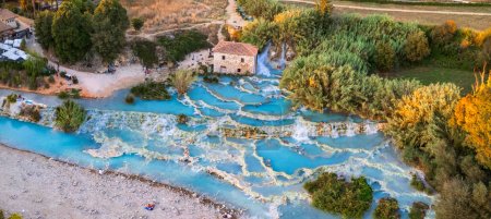 Most famous natural thermal hot spings pools in Tuscany - scenic Terme di Mulino vecchio ( Thermals of Old Windmill) in Grosseto province.  high angle drone view