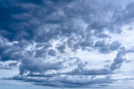 Photo for Clouds in the blue sky. Natural sky background texture, beautiful color. Peaceful blue sky with light clouds. The free form beauty of clouds and sky is perfect for background, backdrop and wallpaper. - Royalty Free Image