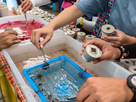 Tourists enjoy in the experiment of growing coral to restore marine environment at the marine farm Coral Conservation and Restoration Center. People try doing coral nursery to restore coral reefs.