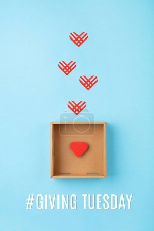Photo for Giving Tuesday, global day of charitable giving after Black Friday shopping day. Charity, give help, donations support concept. Empty brown box and red paper hearts on blue background. Top view, copy space, flat lay. - Royalty Free Image