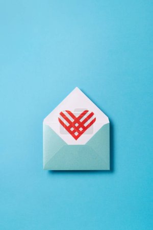 Photo for Giving Tuesday, Global day of charitable giving after Black Friday shopping day. Charity, give help, donations support concept. Red paper heart in blue empty envelope on blue background, top view - Royalty Free Image
