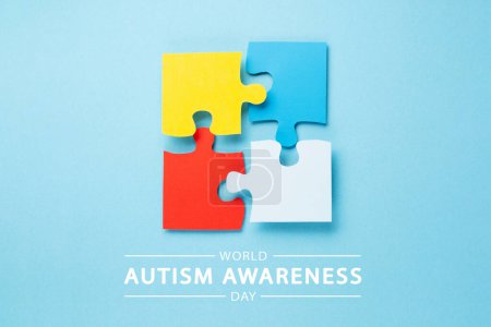 Photo for World Autism Awareness Day or month concept. Creative design for April 2. Color puzzle, symbol of awareness for autism spectrum disorder on blue background. Top view, copy space for text. - Royalty Free Image