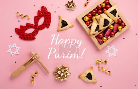 Photo for Purim celebration jewish carnival holiday concept. Tasty hamantaschen cookies, red carnival mask, noisemaker, sweet candies and party decor on pink background. Top view, flat lay, copy space. - Royalty Free Image
