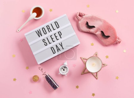 Photo for World Sleep day observed on March 18th. Quality of sleep, good night, insomnia, relaxation concept. Sleeping mask, golden stars, candle, lavender and alarm clock on pink background. Flat lay, top view - Royalty Free Image