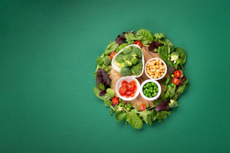 Photo for Vegetarian and vegan diet month in january called Veganuary. Variety of vegan, plant based protein food, healthy raw vegetables. Top view on green background. - Royalty Free Image