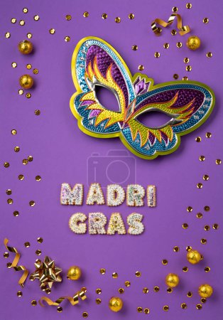 Photo for Mardi Gras masquerade festival carnival Mask, chocolate candies in foil, gold beads and golden confetti on purple background. Holiday party invitation, greeting card concept. - Royalty Free Image