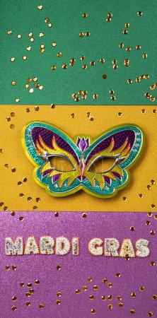 Photo for Mardi Gras King Cake Cookies, masquerade festival carnival Mask and golden sparkle confetti on purple, green, gold background. Holiday party invitation, greeting card concept. - Royalty Free Image