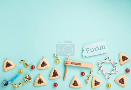 Photo for Purim celebration jewish holiday concept. Tasty hamantaschen cookies, Triangular pastry, Carnival mask, noisemaker, sweet candies and festive party decor on mint green background, Top view, copy space - Royalty Free Image