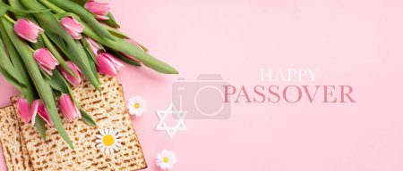 Photo for Jewish holiday Passover greeting card concept with matzah, nuts, tulip and daisy flowers on pink table. Seder Pesach spring holiday background, top view, copy space. - Royalty Free Image
