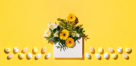 Photo for Festive holiday Easter flower composition. Yellow and white flowers, pastel easter eggs on paper yellow background. Spring, Easter card concept. Flat lay, top view, copy space. - Royalty Free Image
