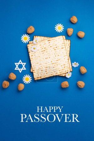 Photo for Jewish holiday Passover greeting card concept with matzah, nuts, spring flowers on blue table. Seder Pesach spring holiday background, top view, copy space. - Royalty Free Image