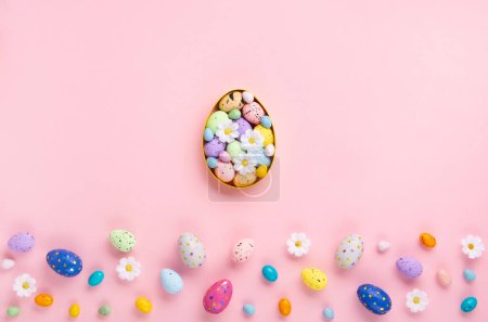 Photo for Sweet Colorful Easter Eggs and spring white daisy flowers on pastel pink background. Happy Easter greeting card concept. Flat lay, top view, copy space. - Royalty Free Image
