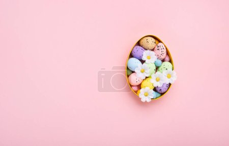 Photo for Sweet Colorful Easter Eggs and spring white daisy flowers on pastel pink background. Happy Easter greeting card concept. Flat lay, top view, copy space. - Royalty Free Image