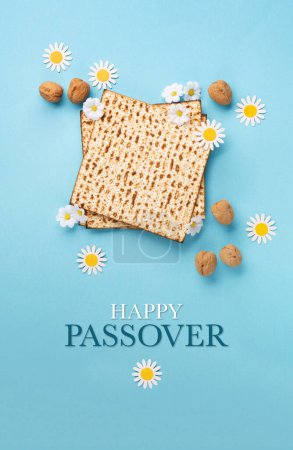 Photo for Jewish holiday Passover greeting card concept with matzah, nuts and daisy flowers on blue table. Seder Pesach spring holiday background, top view, copy space. - Royalty Free Image