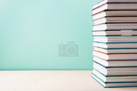 Photo for World book and Copyright day, Education concept. Stack of books on blue mint background. Festive card for books holiday, copy space. - Royalty Free Image