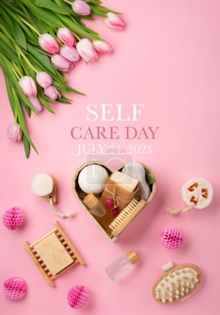 Photo for Happy Self Care Day. Natural eco friendly beauty skin care products, spa accessories for women and spring tulip flowers on pink background. Self care heart shape gift box. Concept of me time - Royalty Free Image