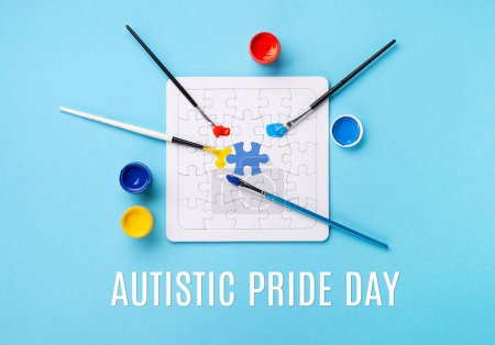 Photo for Autistic Pride Day or World Autism Awareness Day concept. Creative design for April 2. White puzzles, symbol of awareness for autism spectrum disorder and colorful paints on blue background. Top view, copy space. - Royalty Free Image