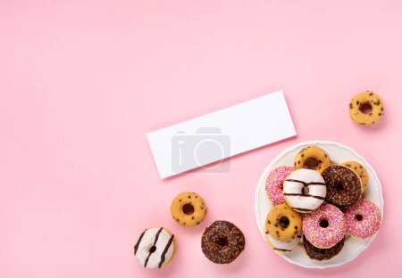Photo for Holiday colorful Donuts doughnuts with chocolate and sugar sprinkles on pink background, top view. Festive carnival or birthday party card. Happy National donut day Concept. - Royalty Free Image