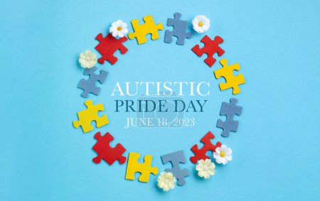 Photo for Autistic Pride Day or World Autism Awareness Day concept. Colorful puzzle, symbol of awareness for autism spectrum disorder and daisy flowers on blue background. Top view, copy space. - Royalty Free Image