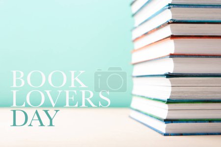 Photo for Book Lovers Day, Education concept. Stack of books on blue mint background. Festive card for books holiday, copy space. - Royalty Free Image